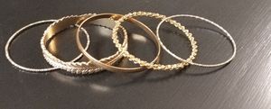 Five goldtone bangle bracelets